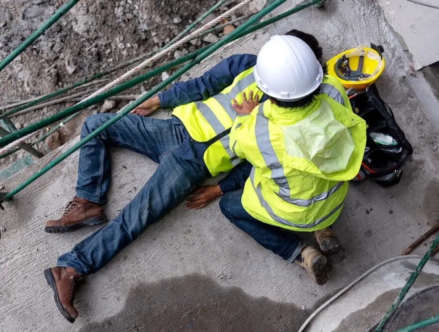 First aid support accident at work of construction worker at site.