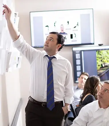 Man pointing to something on the wall