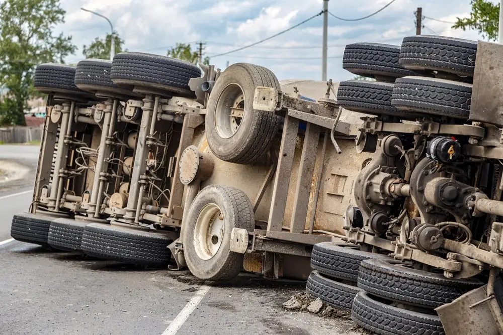 View of an overturned truck on an highway in an accident.