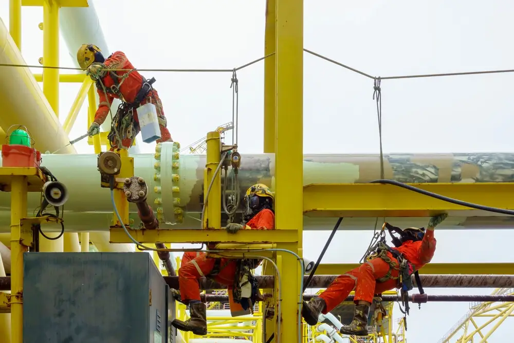 A group of abseilers wearing personal protective equipment (ppe)