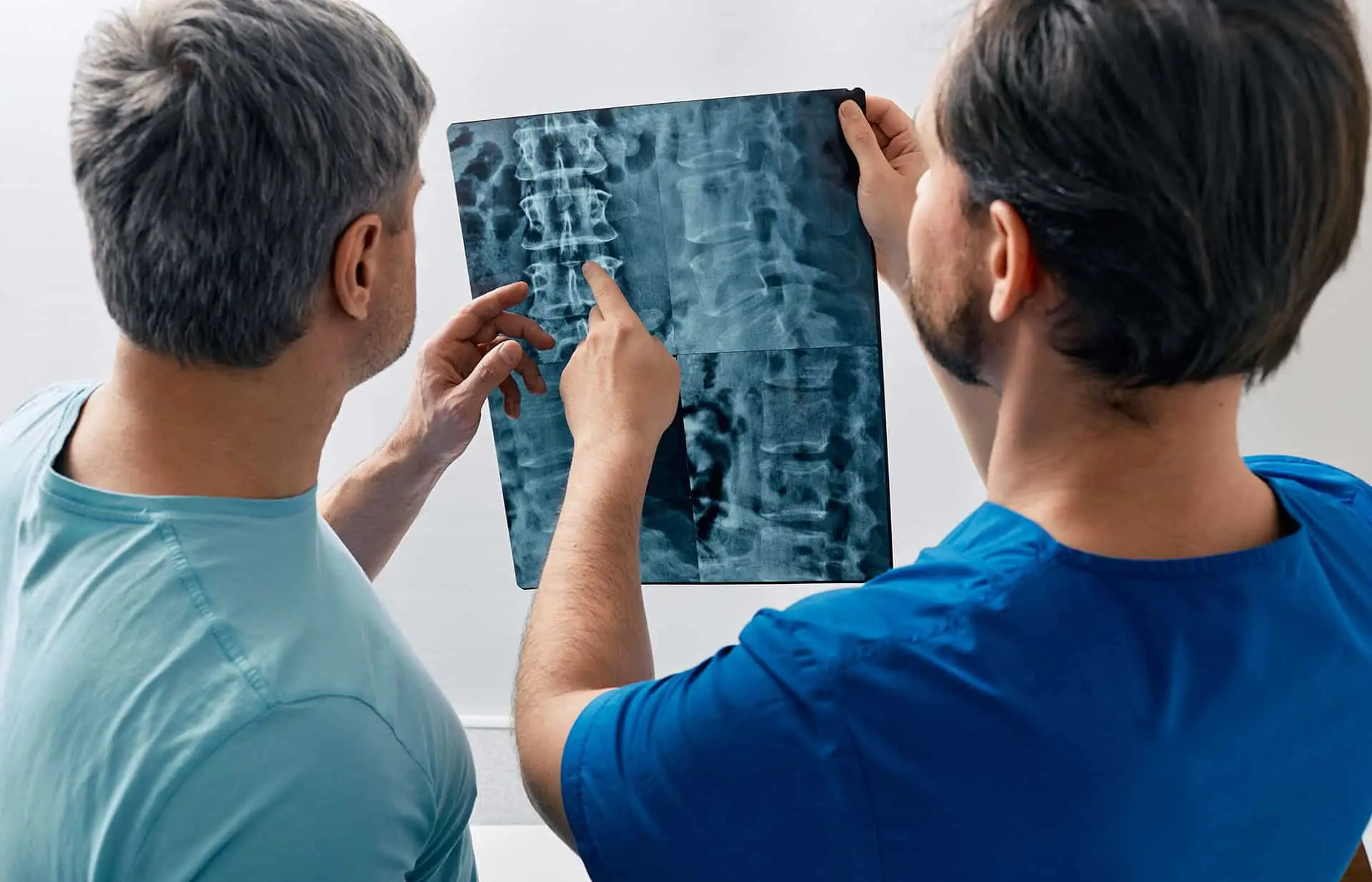 Manual therapist viewing x-ray of backbone