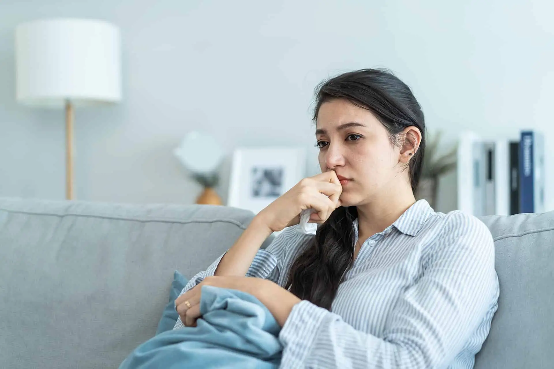 Asian beautiful unhappy woman sit on sofa feel frustrated and stressed