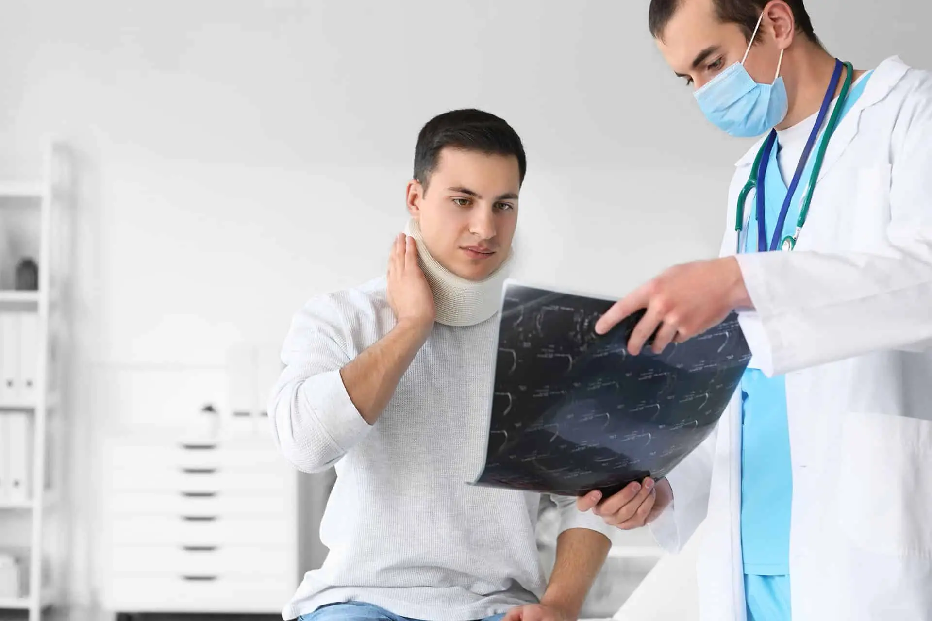 Young man with neck injury visiting doctor in clinic