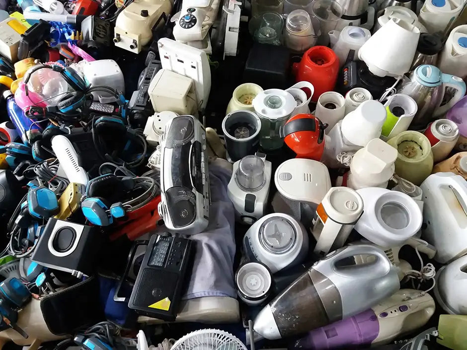 Pile of used electronic and housewares waste division broken or damage