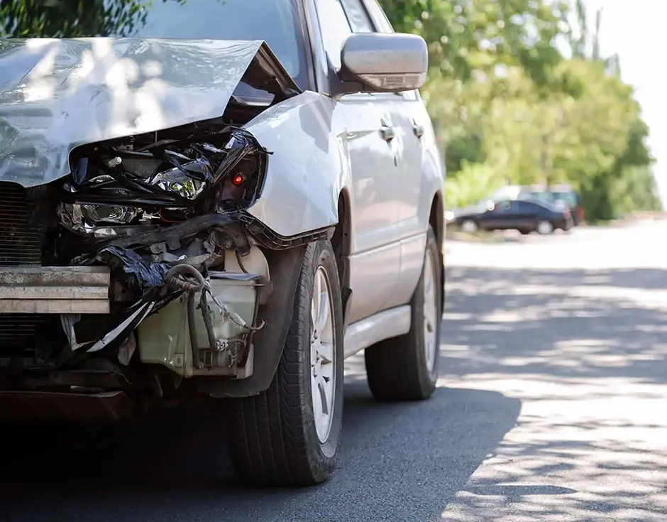 Destroyed car in car crash traffic accident on city road with copy space on city road.