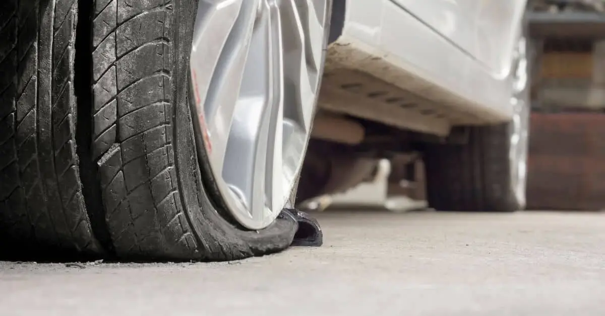 close up of a blown tire on a car sit