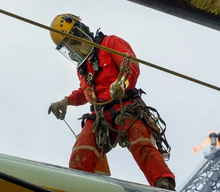 An abseiler wearing personal protective equipment (ppe)