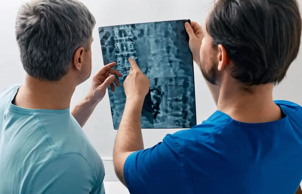 Manual therapist viewing x-ray of backbone