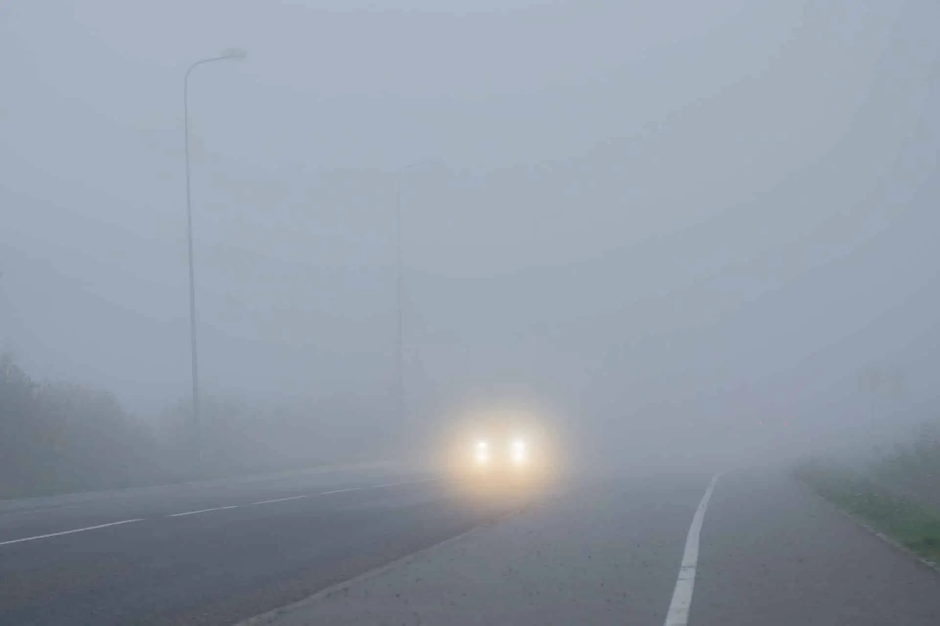 Poor visibility in fog on road