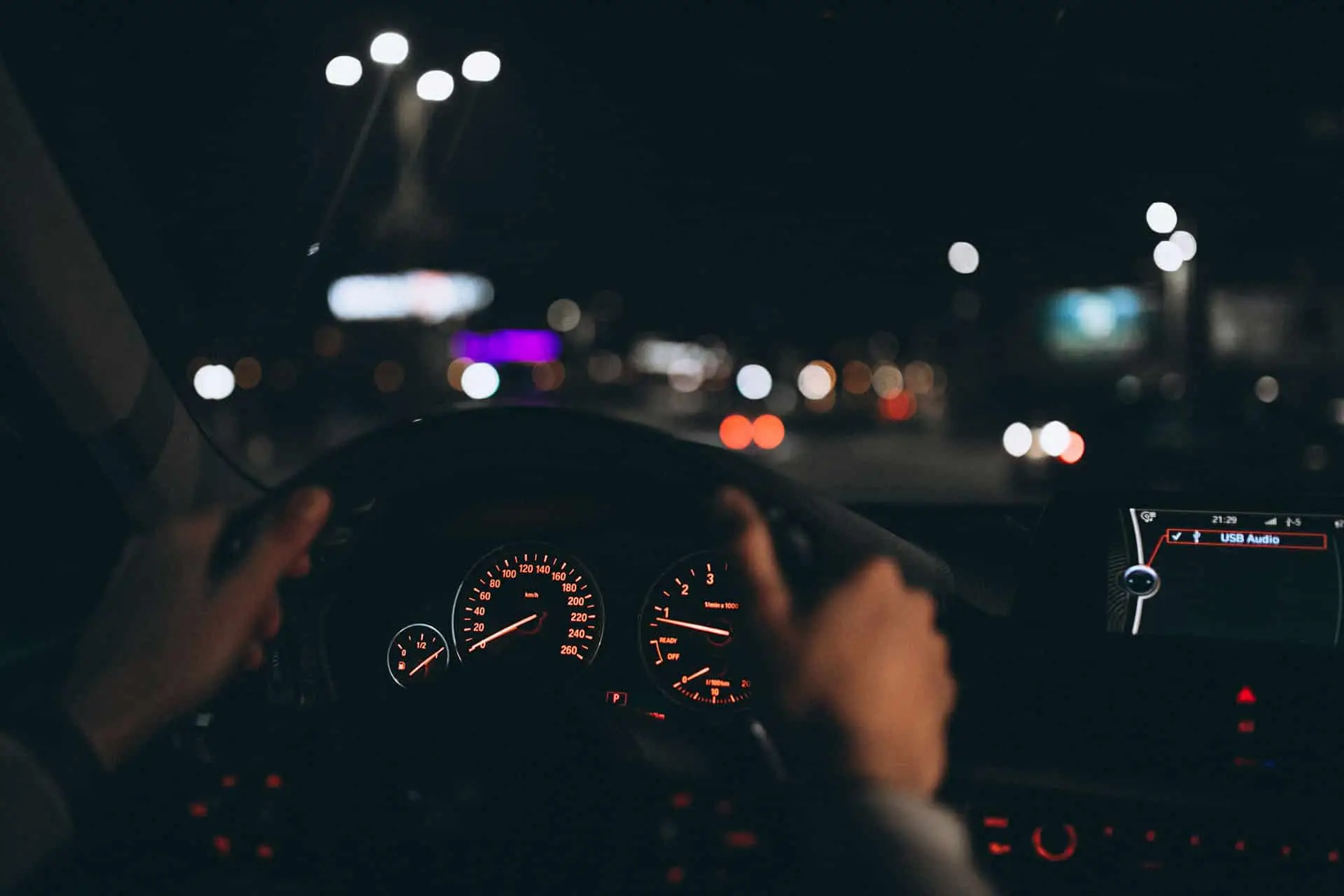 Young man driving his car at a night time