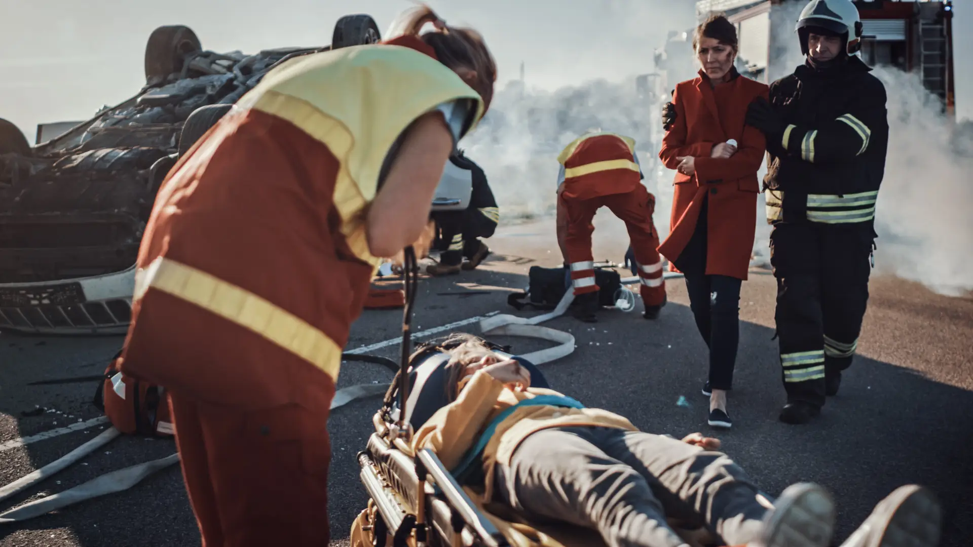 Emergency medical personnel assisting a catastrophically injured person after an accident