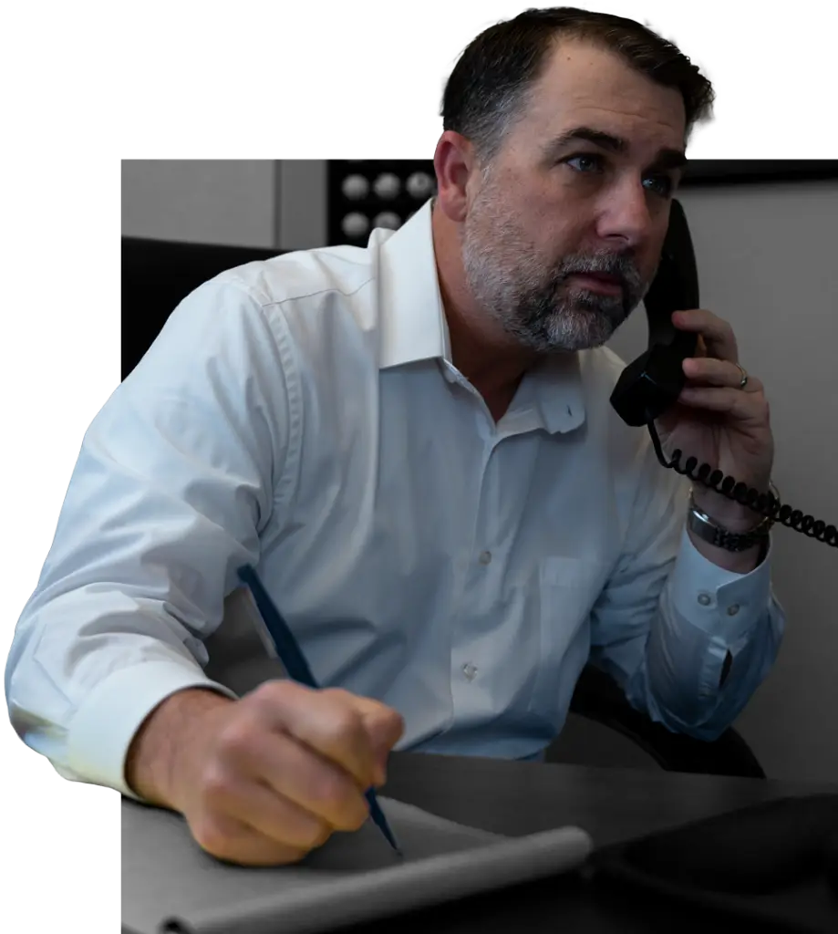 Male attorney on the phone with a client, taking notes