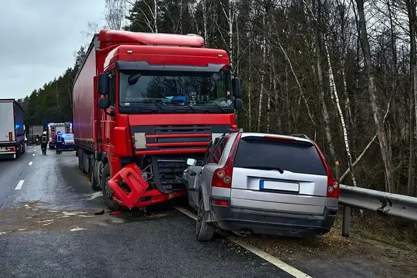 Car after a collision with a heavy truck, transportation background