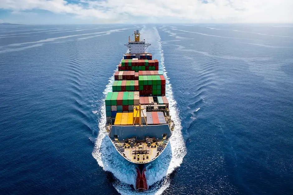 an international waters cargo vessel full of containers at seas representign a jones act vessel