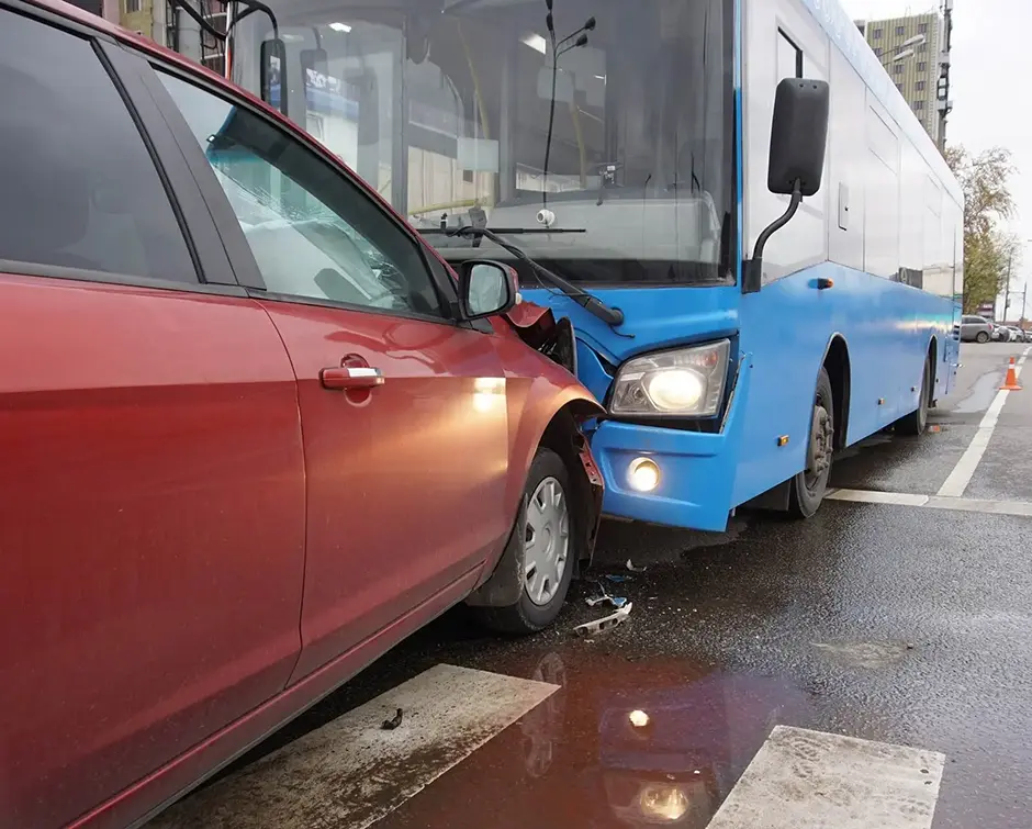 Head-on collision of a car and a bus at a pedestrian crossing
