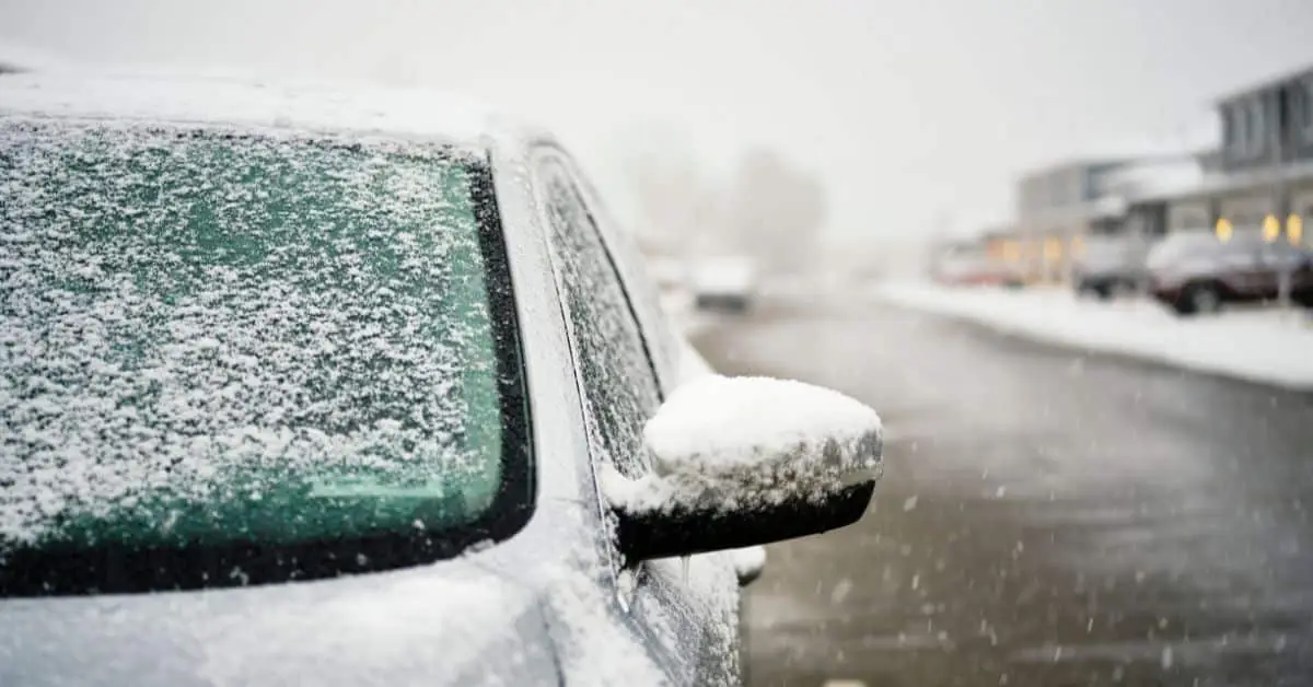 snow-covered vehicle sitting in a parking lot