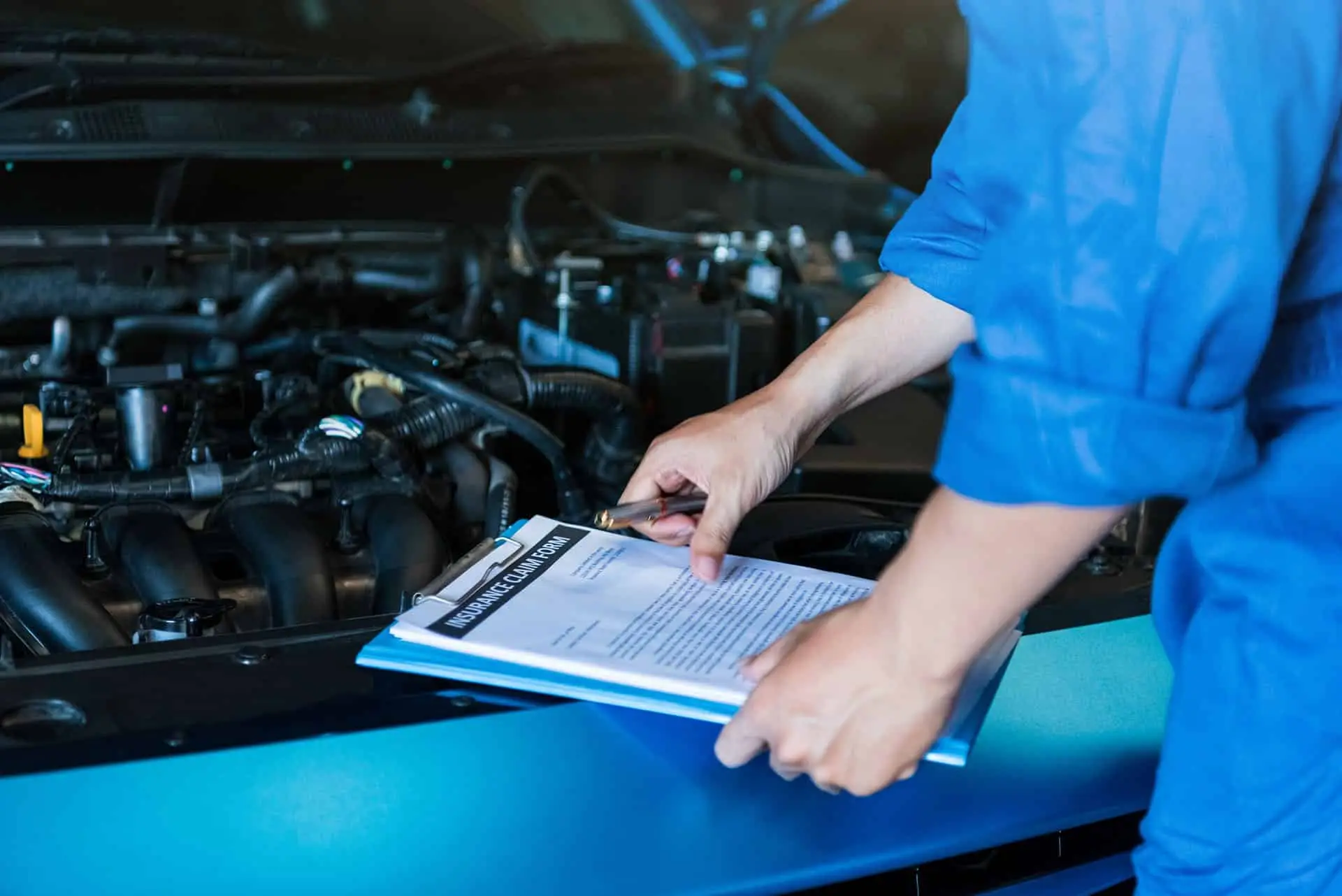 Car mechanic holding clipboard
